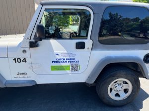 An image of a white, right hand drive Jeep Wrangler with a Sacramento-Yolo Mosquito and Vector Control District decal on the door.